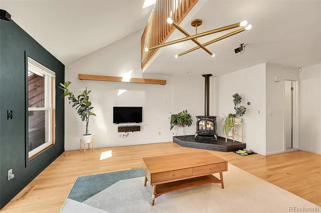 a living room with furniture flat screen tv and a potted plant