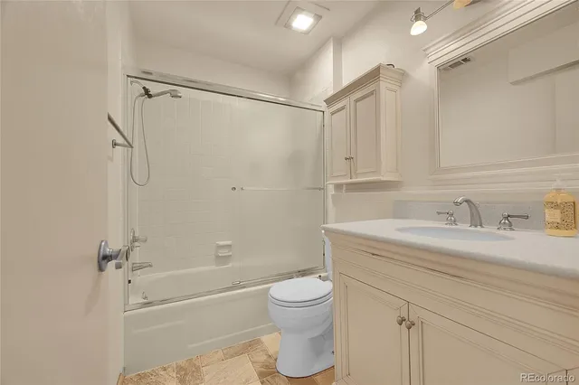 a bed room with a bed and a view of living room