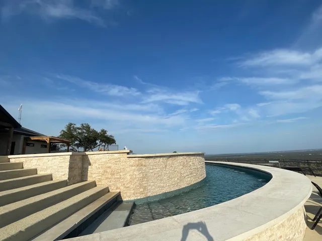 a view of swimming pool with a yard