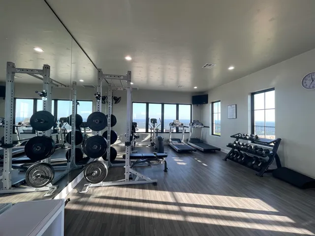 a living room with furniture a ceiling fan and a chandelier
