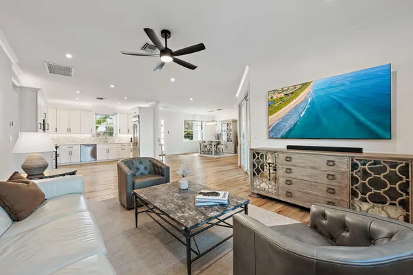 a living room with furniture and wall paintings