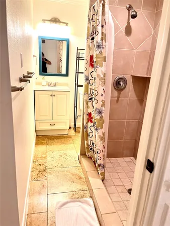 a bathroom with a bathtub and shower
