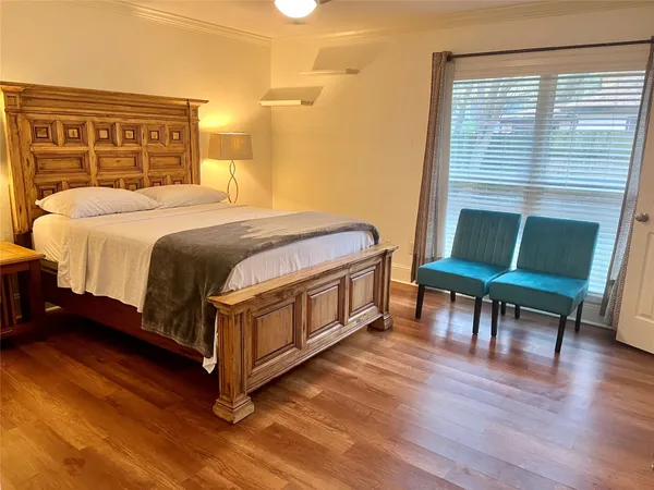 a bedroom with a bed chair and a window