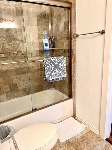 a bathroom with a toilet and a shower