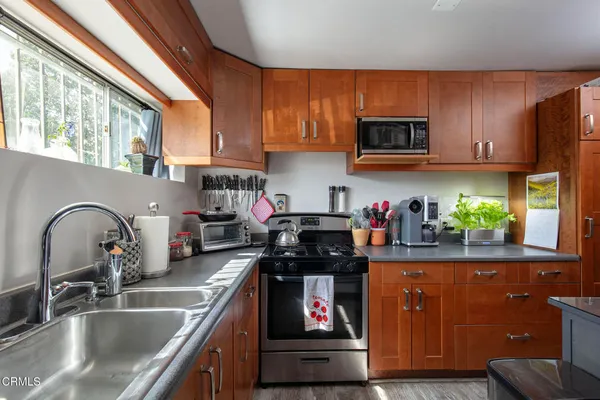 a view of a kitchen with furniture and wooden floor