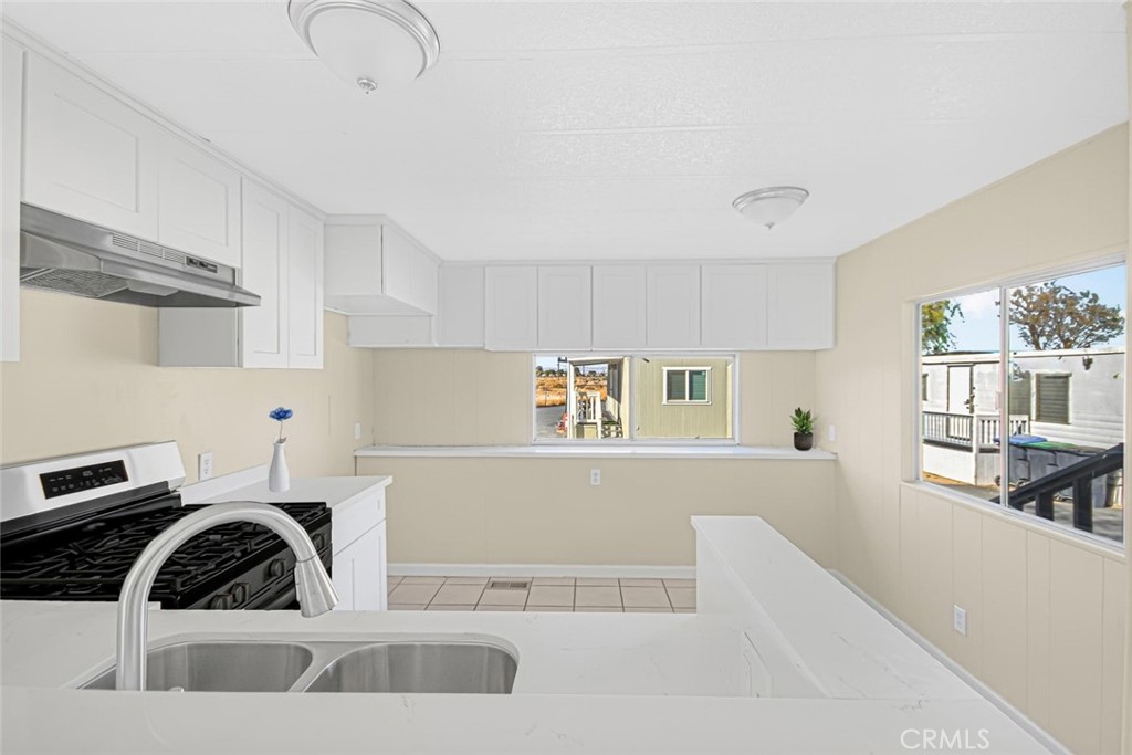 45131 28th Street East, Unit 19 Lancaster, CA 93535 - Photo 5 of 14 a kitchen with a sink a stove and cabinets