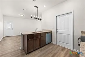 a kitchen with a sink and chandelier