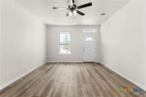 wooden floor in an empty room with a window
