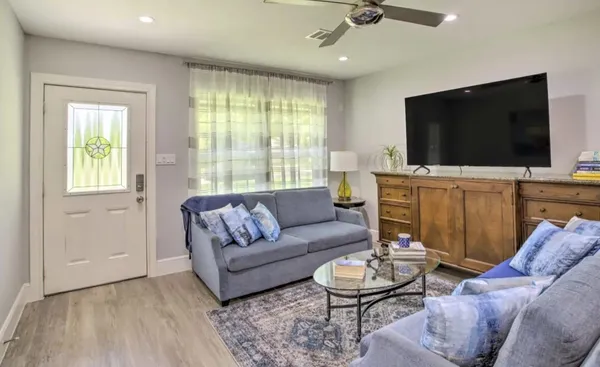 a living room with furniture and a flat screen tv