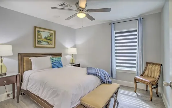 a bedroom with a bed and a chair