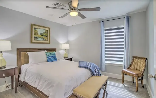 a bedroom with a bed and a chair