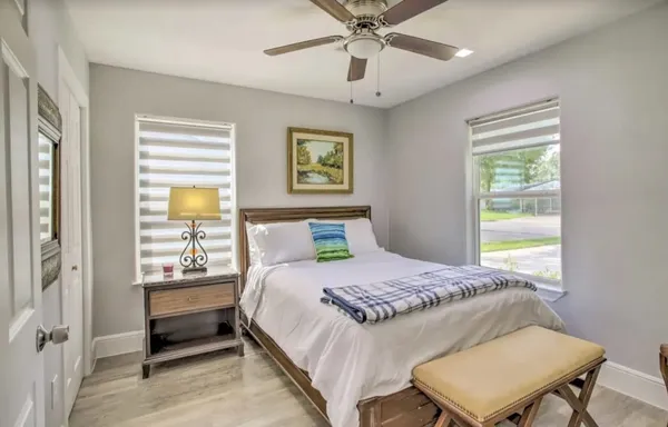 a bedroom with a bed and a window