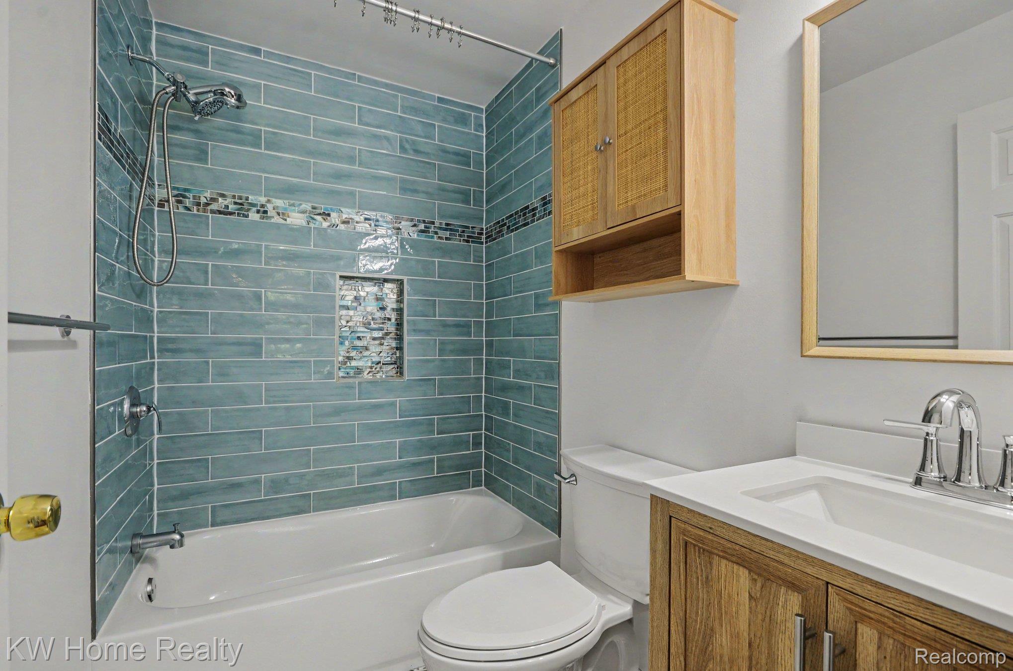 2383 East Maple Road Troy, MI 48083 - Photo 15 of 25 Bathroom featuring a tub and shower combination with subway tile surround, mosaic accent tile, and a built-in shower niche