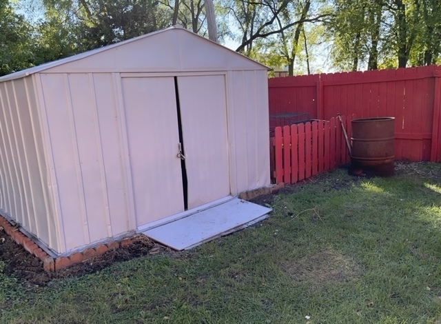108 South 12th Street Rochelle, IL 61068 - Photo 15 of 17 a view of a backyard with potted plants and wooden fence