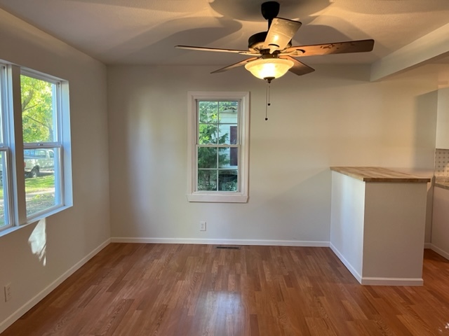 108 South 12th Street Rochelle, IL 61068 - Photo 3 of 17 a view of an empty room with wooden floor and a window