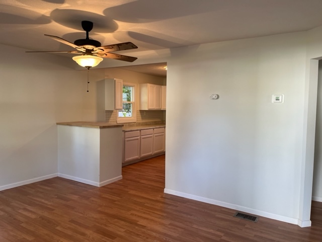 108 South 12th Street Rochelle, IL 61068 - Photo 4 of 17 a view of a kitchen from a ceiling fan hardwood floor and a ceiling fan
