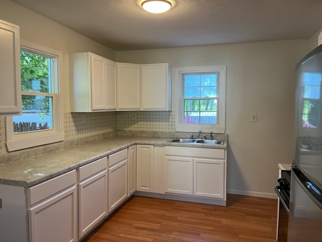 108 South 12th Street Rochelle, IL 61068 - Photo 6 of 17 a kitchen with stainless steel appliances granite countertop a sink stove and cabinets