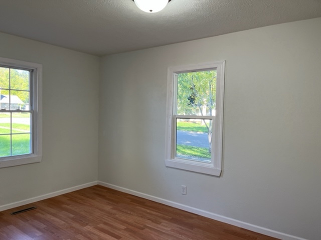 108 South 12th Street Rochelle, IL 61068 - Photo 10 of 17 an empty room with wooden floor and windows