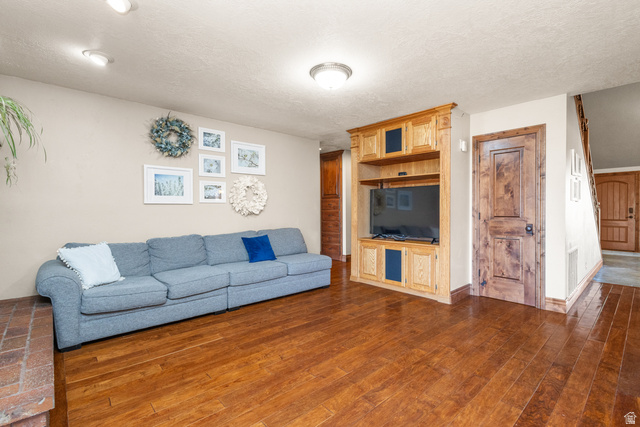 892 Cambridge Drive St. George, UT 84770 - Photo 23 of 65 Living area featuring wood-finish flooring, a built-in entertainment center, and recessed lighting
