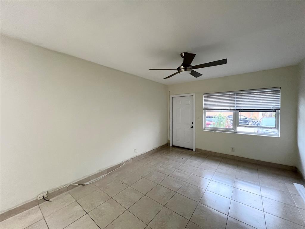 431 Southeast 19th Avenue, Unit 2 Pompano Beach, FL 33060 - Photo 4 of 7 a view of an empty room and window