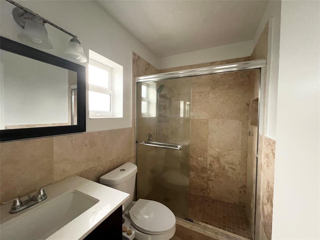 431 Southeast 19th Avenue, Unit 2 Pompano Beach, FL 33060 - Photo 7 of 7 a bathroom with a sink mirror toilet and shower