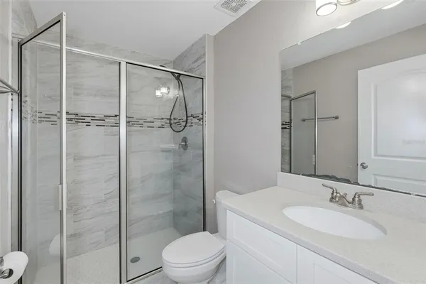 a bathroom with a toilet a sink and shower