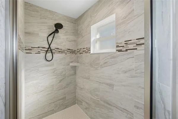 a bathroom with a glass shower door
