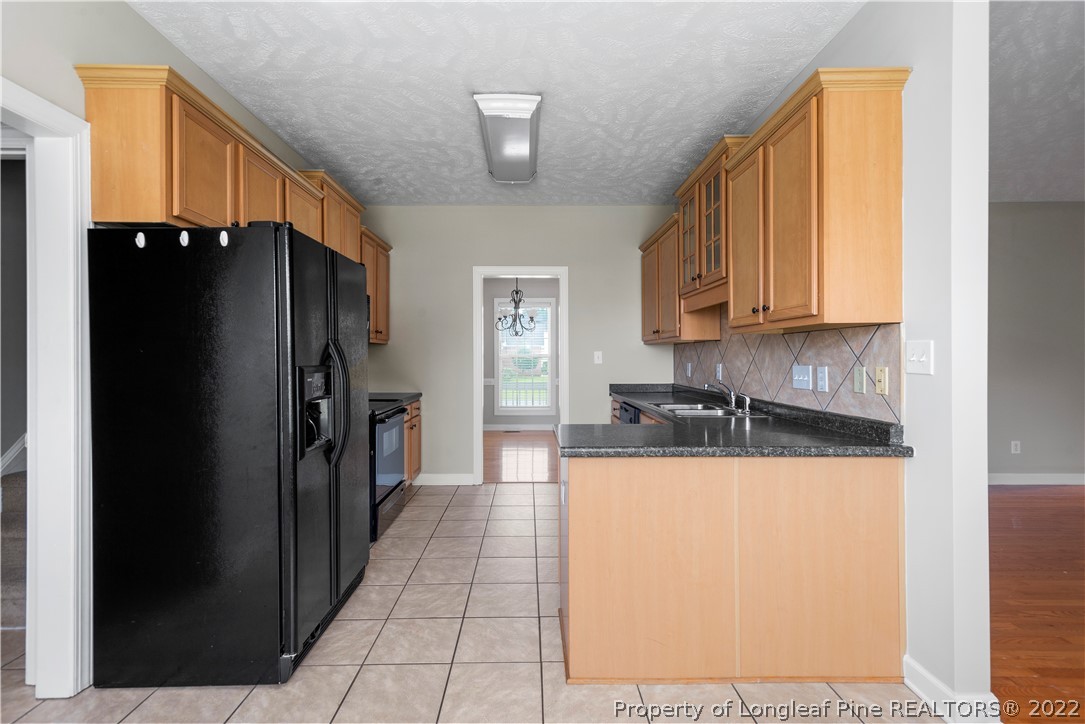 3612 Talus Road Fayetteville, NC 28306 - Photo 11 of 29 a kitchen with stainless steel appliances a refrigerator and a sink