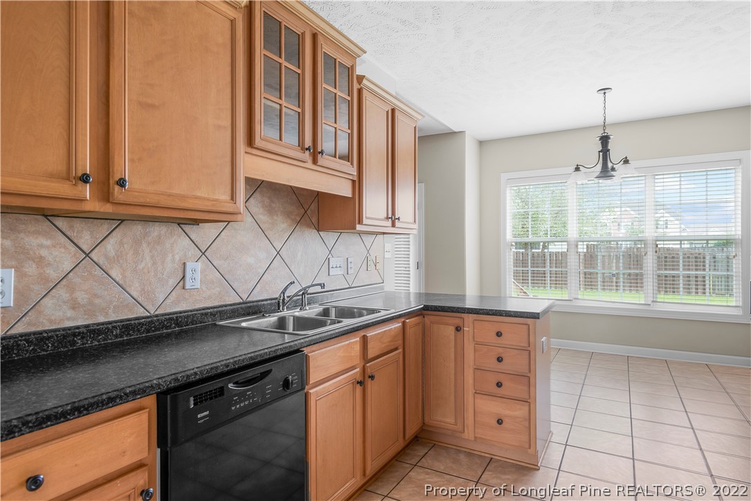 3612 Talus Road Fayetteville, NC 28306 - Photo 12 of 29 a kitchen with granite countertop a sink and a stove