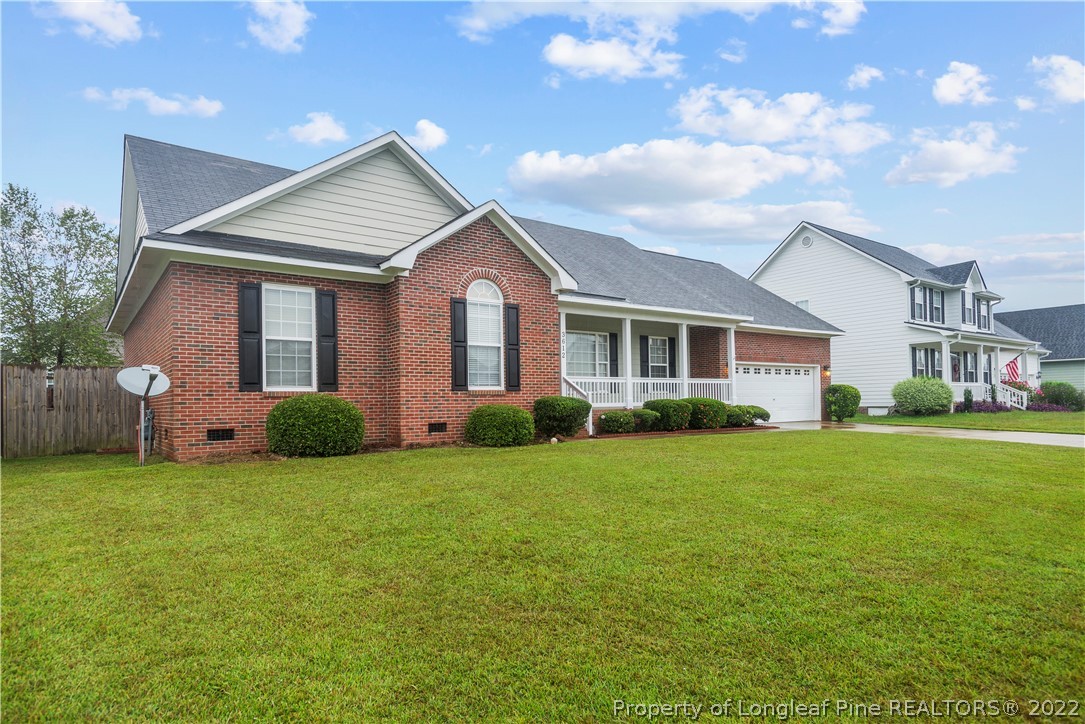 3612 Talus Road Fayetteville, NC 28306 - Photo 2 of 29 a view of a house next to a big yard and large trees