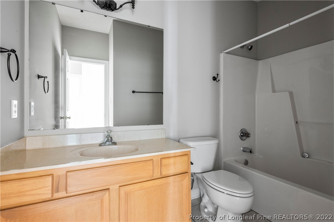 3612 Talus Road Fayetteville, NC 28306 - Photo 22 of 29 a bathroom with a sink toilet vanity and shower