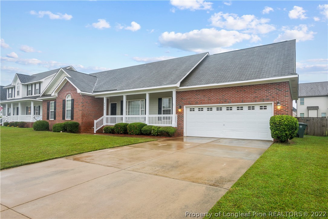 3612 Talus Road Fayetteville, NC 28306 - Photo 3 of 29 a view of a house with a yard and garage