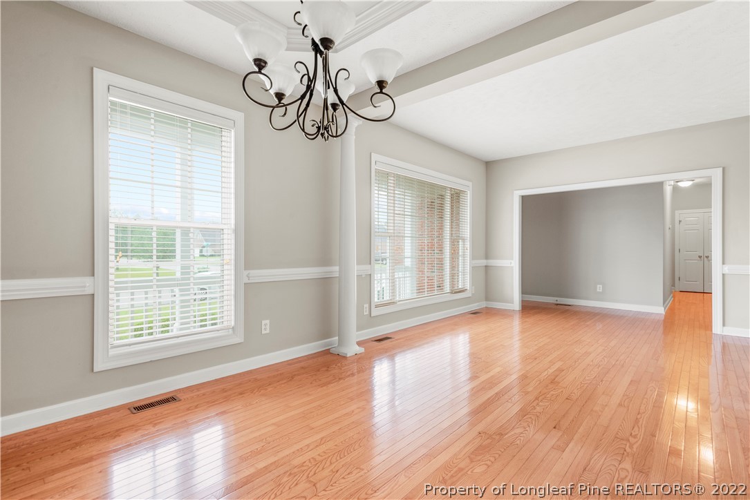 3612 Talus Road Fayetteville, NC 28306 - Photo 9 of 29 a view of an empty room with wooden floor and a window
