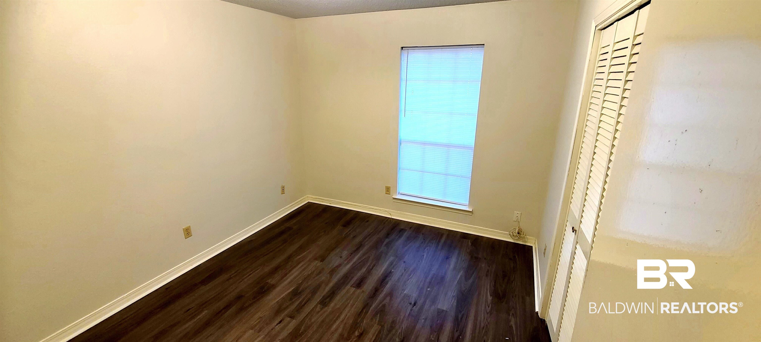 5305 Wilhelm Drive Mobile, AL 36618 - Photo 8 of 16 Unfurnished bedroom featuring a closet and dark hardwood / wood-style flooring