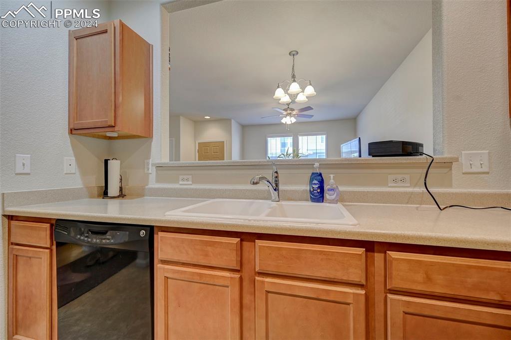 7675 Sandy Springs Point Fountain, CO 80817 - Photo 12 of 32 a kitchen with cabinets and chandelier