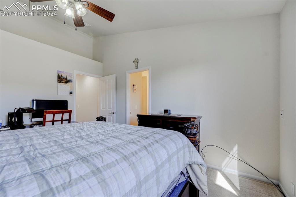 7675 Sandy Springs Point Fountain, CO 80817 - Photo 16 of 32 a bedroom with a bed and a chandelier