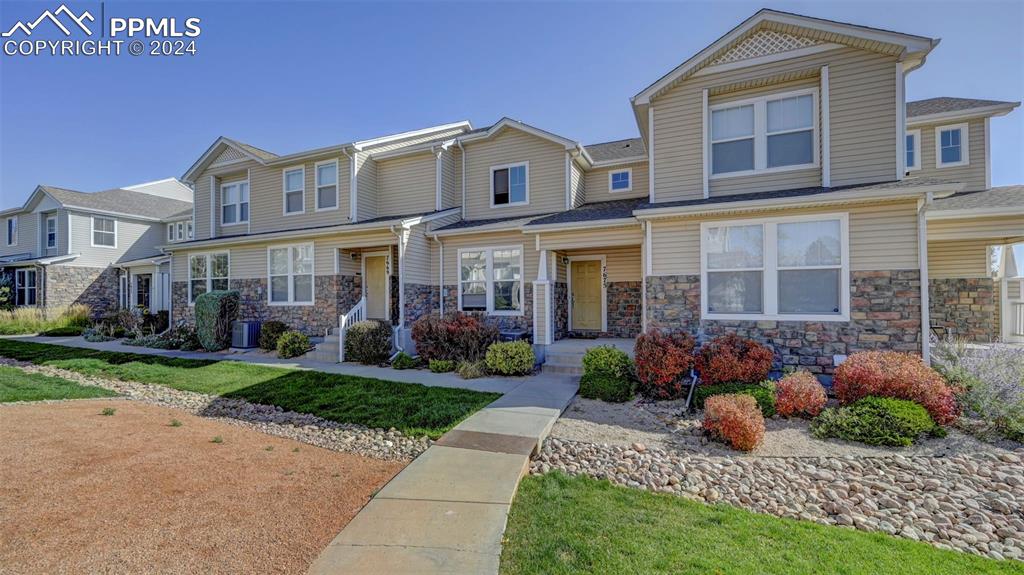 7675 Sandy Springs Point Fountain, CO 80817 - Photo 2 of 32 a front view of a house with garden and porch