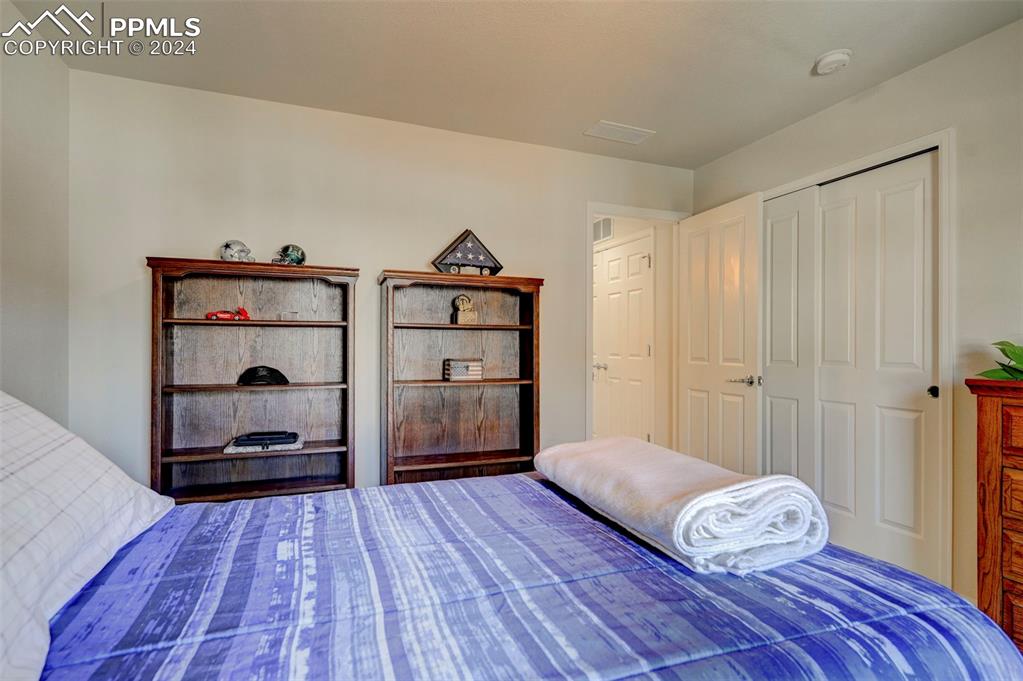 7675 Sandy Springs Point Fountain, CO 80817 - Photo 21 of 32 a bedroom with a bed and a window