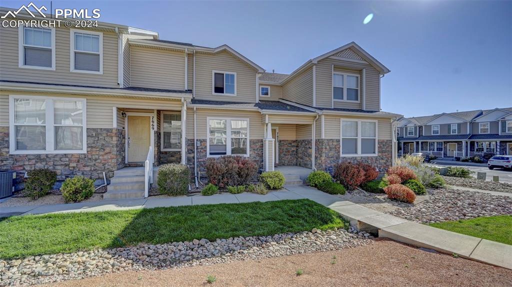 7675 Sandy Springs Point Fountain, CO 80817 - Photo 32 of 32 a view of a brick house with a yard and plants