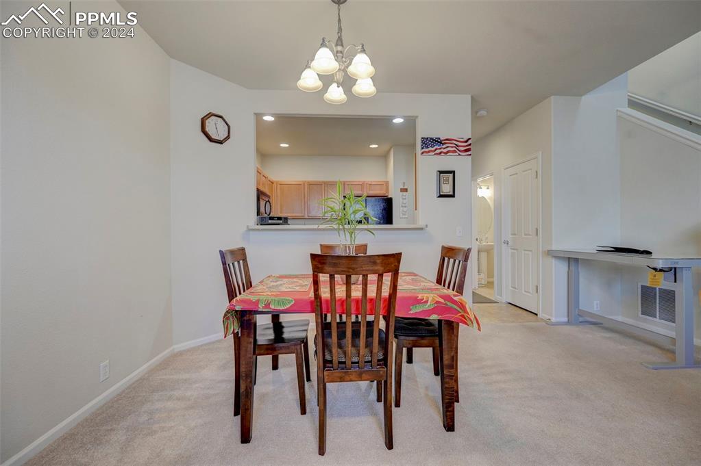 7675 Sandy Springs Point Fountain, CO 80817 - Photo 9 of 32 a view of a dining room with furniture and chandelier