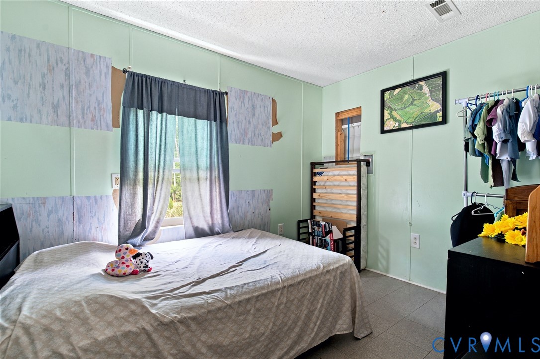 1451 Dixie Hill Road Dillwyn, VA 23936 - Photo 19 of 51 Room featuring light green walls with patterned pa