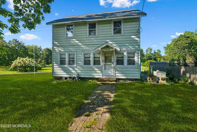 a front view of a house with a yard table and chairs