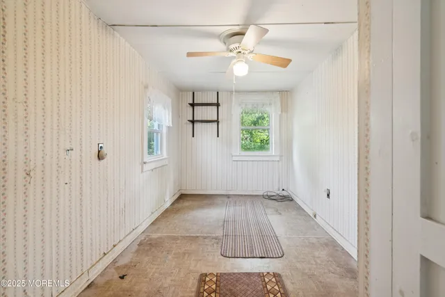 an empty room with windows and closet