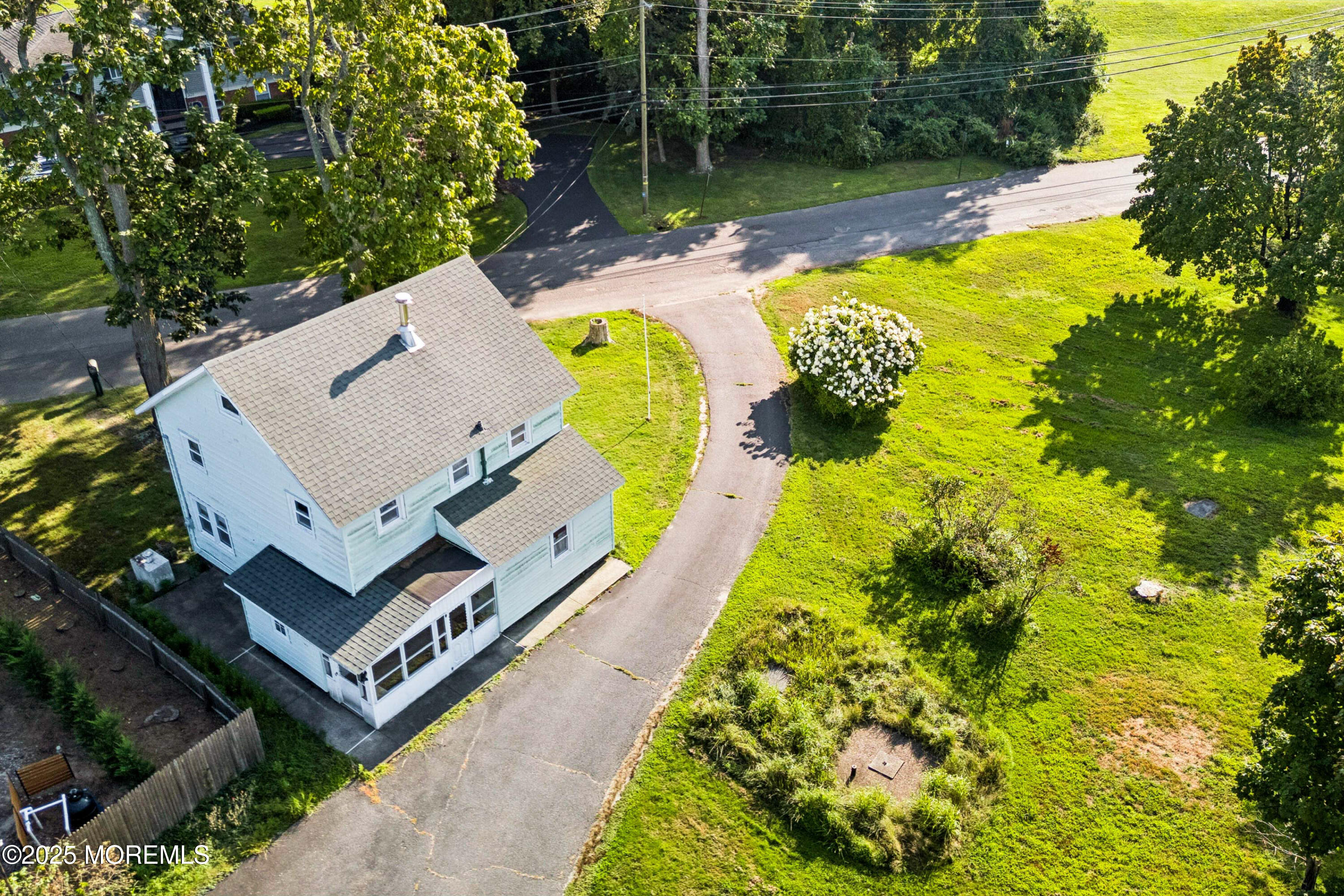 2628 East Hurley Pond Road Wall, NJ 07719 - Photo 20 of 40 an aerial view of a house with swimming pool and lake view