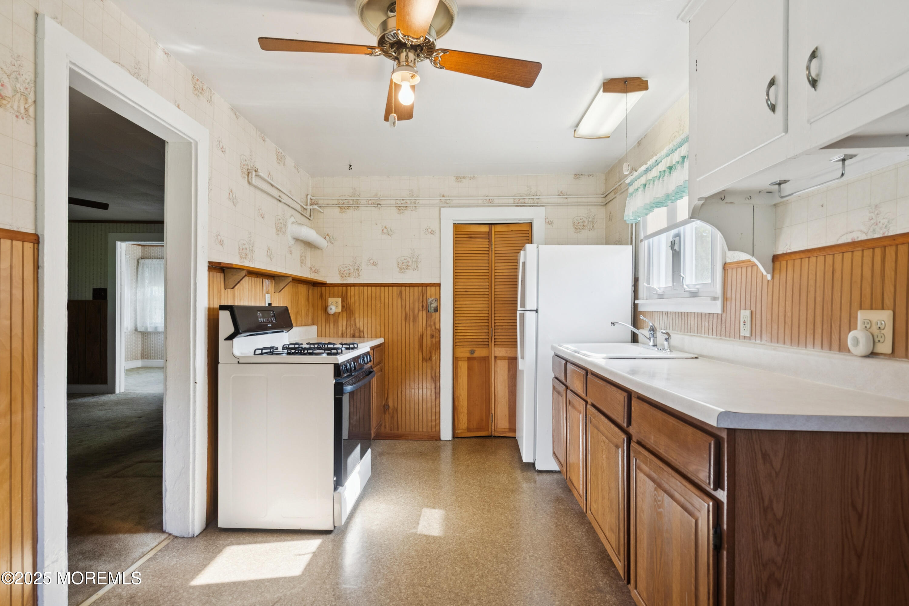 2628 East Hurley Pond Road Wall, NJ 07719 - Photo 28 of 40 a kitchen with a refrigerator and a sink