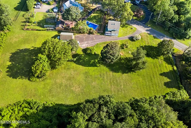 an aerial view of a house with a garden and trees