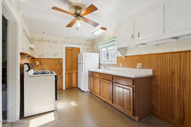 a kitchen with refrigerator cabinets and a sink