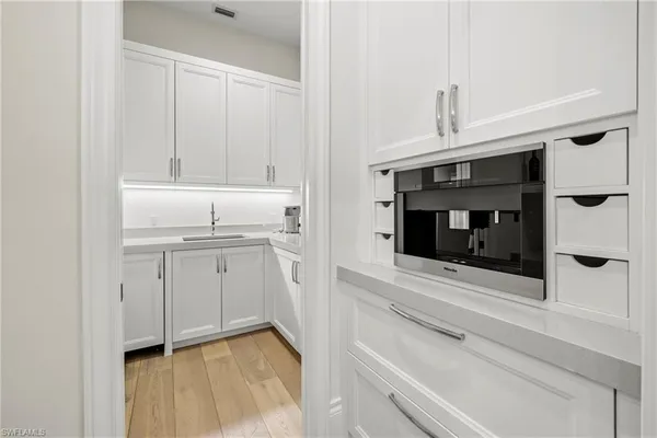 a kitchen with a sink and a microwave