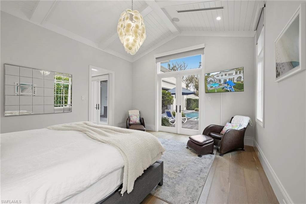 215 3rd Avenue North Naples, FL 34102 - Photo 13 of 47 Bedroom with access to exterior, french doors, hardwood / wood-style flooring, and suspended lighting