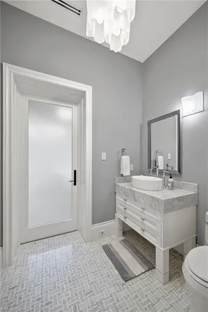 a view of a bathroom with a sink a mirror and a toilet